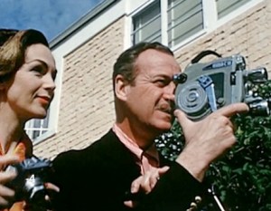 Hjordis and David Niven with cameras, 1955
