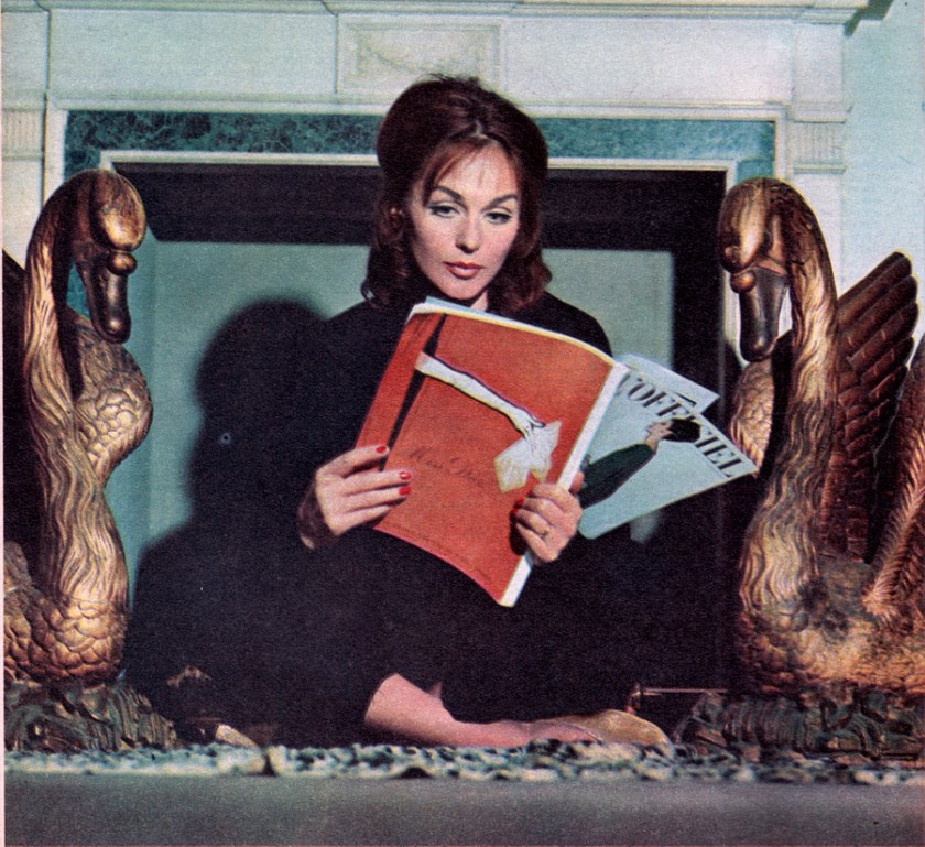 Hjordis Niven reading the March 1960 edition of L'Officiel fashion magazine.