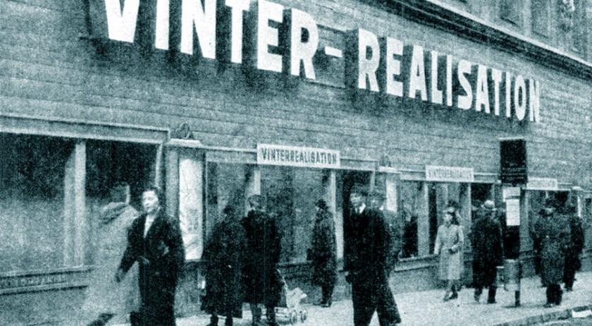 Boarded-up shop display windows in wartime Stockholm.