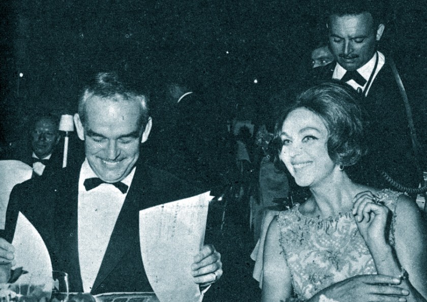 Prince Rainier and Hjordis Niven watching dancers perform at a charity bash in Monte Carlo, August 1964